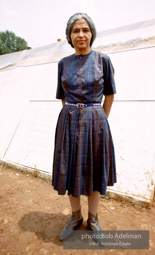 Rosa Parks stands in front of a shanty at 