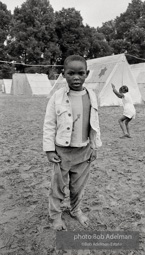 Children of Poor People March demonstrators play in mud in front of temporary structures at  
