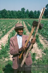 Basket Maker Ben Jones splits off strips from a four foot log.- From the LIFE magazine story Artists of the Black Belt, 1983.