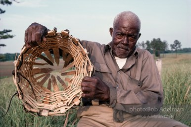 Preston Brown at work building one of his fish baskets - From the LIFE magazine story Artists of the Black Belt, 1983. Preston Brown at work building one of his fish baskets - From the LIFE magazine story Artists of the Black Belt, 1983.