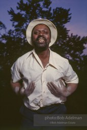 Hambone player Albert Stanton slaps his body to accompany his own lyrics about farm life.- From the LIFE magazine story Artists of the Black Belt, 1983.