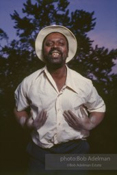 Hambone player Albert Stanton slaps his body to accompany his own lyrics about farm life.- From the LIFE magazine story Artists of the Black Belt, 1983. Hambone player Albert Stanton slaps his body to accompany his own lyrics about farm life.- From the LIFE magazine story Artists of the Black Belt, 1983.