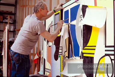 Roy Lichtenstein at work on his painting 