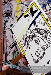Roy Lichtenstein painting 'Reflections:Wonder Woman (his brushstroke painting 'Laocoon' visible in background).1989. photo:©Bob Adelman Estate, Artwork©Estate of Roy Lichtenstein