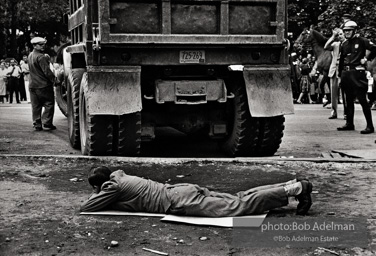 Stop action: Determined to end unfair hiring practices, two protestors put their lives on the line, closing down a construction site at the Downstate Medical Center, Brooklyn, New York City.  1963