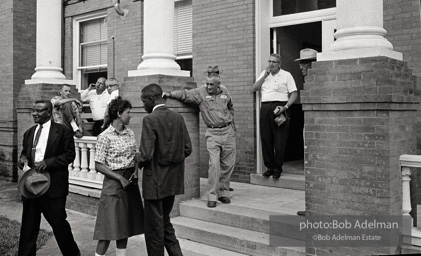 After eight years of trying, the Reverend Joe Carter succeeds in registering to vote then is jeered as he walks down the courthouse steps, St. Francisville, Louisiana. 1964
“Joe Carter was the first African American in his parish to register to vote in the twentieth century — this despite the fact that two out of three residents of the parish were black. Once he succeeded in his quest, danger was in the air. I remember someone at the courthouse shouting at me, ‘Take his picture, it may be the last one he takes.’” After eight years of trying, the Reverend Joe Carter succeeds in registering to vote then is jeered as he walks down the courthouse steps, St. Francisville, Louisiana. 1964
“Joe Carter was the first African American in his parish to register to vote in the twentieth century — this despite the fact that two out of three residents of the parish were black. Once he succeeded in his quest, danger was in the air. I remember someone at the courthouse shouting at me, ‘Take his picture, it may be the last one he takes.’”