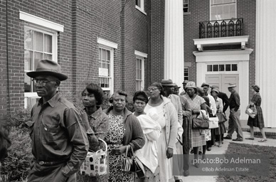 A new day dawns: Voters, most of them about to fill out their first-ever ballots, line up at the courthouse, Camden, Alabama. 1966-
“The Voting Rights Act of 1965 changed everything, outlawing literacy tests and other barriers. It made it possible for thousands of black officials to eventually be elected in the South, and it certainly helped in
the election of two white southerners to the presidency. It was a large
factor in the gradual decrease of racial tension throughout the South. In a rare show of unity, more than forty years after the Voting Rights Act was passed, Congress renewed the measure unanimously.” A new day dawns: Voters, most of them about to fill out their first-ever ballots, line up at the courthouse, Camden, Alabama. 1966-
“The Voting Rights Act of 1965 changed everything, outlawing literacy tests and other barriers. It made it possible for thousands of black officials to eventually be elected in the South, and it certainly helped in
the election of two white southerners to the presidency. It was a large
factor in the gradual decrease of racial tension throughout the South. In a rare show of unity, more than forty years after the Voting Rights Act was passed, Congress renewed the measure unanimously.”