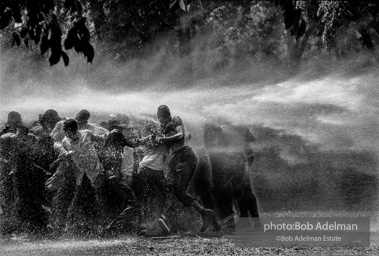 No man is an island, Kelly Ingram Park, Birmingham, Alabama. 1963
“The police and firemen used a brute show of force to try to stop the ongoing demonstrations. It didn’t work on this day. Rather than fleeing, the protestors hung on to each other and were able to stand up to the full fury of the water, though not without casualties. I have never witnessed such cruelty. There was almost as much moisture behind the lens as in front. I gave a print of this picture to Dr. King. He studied it and said, ‘I am startled that out of so much pain some beauty came. No man is an island, Kelly Ingram Park, Birmingham, Alabama. 1963
“The police and firemen used a brute show of force to try to stop the ongoing demonstrations. It didn’t work on this day. Rather than fleeing, the protestors hung on to each other and were able to stand up to the full fury of the water, though not without casualties. I have never witnessed such cruelty. There was almost as much moisture behind the lens as in front. I gave a print of this picture to Dr. King. He studied it and said, ‘I am startled that out of so much pain some beauty came.