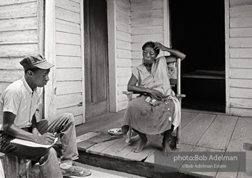 CORE worker Danny Williams canvassing at a woman’s house, West Feliciana Parish, LA 1964