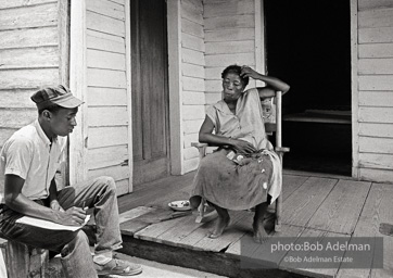 CORE worker Danny Williams canvassing at a woman’s house, West Feliciana Parish, LA 1964 CORE worker Danny Williams canvassing at a woman’s house, West Feliciana Parish, LA 1964
