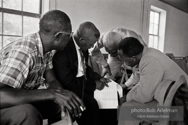 Rev. Carter and others reviewing the registration form prior to
attempting to register, West Feliciana Parish, LA 1963