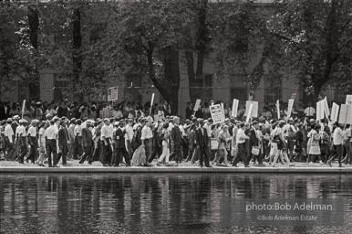 Crowd moving along the Reflecting Pool, Washington DC 1963. After songs and speeches at the Washington Monument, marchers walked down the Reflecting Pool to the base of the Lincoln Memorial. March leaders had been meeting with congressional leaders at the Capitol and had to hurry to catch up to the advancing marchers.