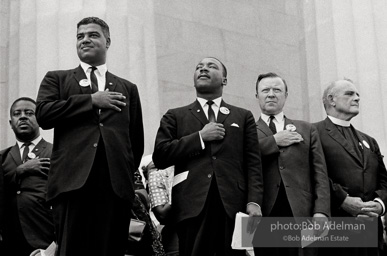 Leaders including the Reverend Ralph Abernathy (far left), National Urban League Director Whitney Young Jr. (left), and Walter Reuther head of the CIO (right) Jjoin King to pledge allegiance at the beginning of the ceremony at the Lincoln Memorial, Washington D.C. August 28, 1963