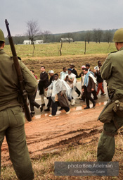 “With helicopters whirring above and the 54 miles of highway closely guarded by U.S. Army troops and the Alabama National Guard, the march into the Cradle of the Confederacy, Montgomery, was the greatest display of the power of the people’s right to peacefully petition since Gandhi’s Salt March to the sea. King’s ultimate faith in American justice was rewarded by the military’s
protection, by President Johnson’s vow that ‘we shall overcome’ and by Johnson’s call for passage of a voting rights bill.” 1965 “With helicopters whirring above and the 54 miles of highway closely guarded by U.S. Army troops and the Alabama National Guard, the march into the Cradle of the Confederacy, Montgomery, was the greatest display of the power of the people’s right to peacefully petition since Gandhi’s Salt March to the sea. King’s ultimate faith in American justice was rewarded by the military’s
protection, by President Johnson’s vow that ‘we shall overcome’ and by Johnson’s call for passage of a voting rights bill.” 1965