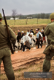 “With helicopters whirring above and the 54 miles of highway closely guarded by U.S. Army troops and the Alabama National Guard, the march into the Cradle of the Confederacy, Montgomery, was the greatest display of the power of the people’s right to peacefully petition since Gandhi’s Salt March to the sea. King’s ultimate faith in American justice was rewarded by the military’s
protection, by President Johnson’s vow that ‘we shall overcome’ and by Johnson’s call for passage of a voting rights bill.”  1965