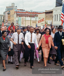 Leading a throng of 25,000 marchers, Dr. Ralph Bunche, King, and Coretta Scott King lead the march into Montgomery on the fifth day,
Montgomery 1965