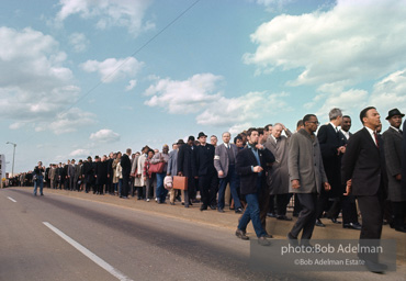 Crossing over: King leads the Montgomery-bound marchers over the Edmund Pettus Bridge, which was already famous for shocking scenes of police brutality,   Selma,  Alabama.  1965
