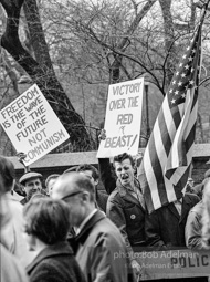 Marchers and onlookers, both for and against the war in Vietnam. Near Central Park in New York City.