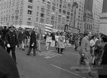 Marchers and onlookers, both for and against the war in Vietnam. Near Central Park in New York City.