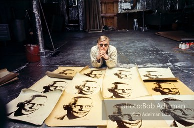 Andy Warhol with prints of TheAmerican Man (Portraitof Watson Powell) (1964)on the Factory floor.