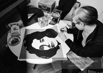 Andy Warhol signs his Liz Taylor prints at the Leo Castelli Gallery. New York City, 1965.