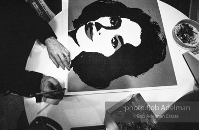 Andy Warhol signs his Liz Taylor prints at the Leo Castelli Gallery. New York City, 1965.