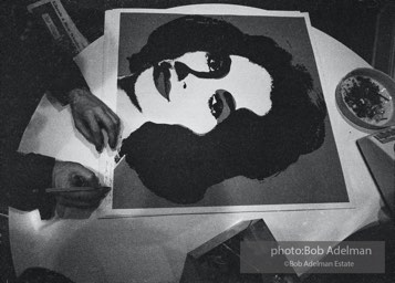 Andy Warhol signs his Liz Taylor prints at the Leo Castelli Gallery. New York City, 1965.