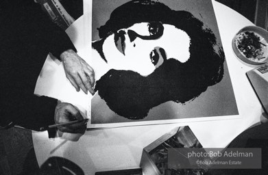 Andy Warhol signs his Liz Taylor prints at the Leo Castelli Gallery. New York City, 1965.