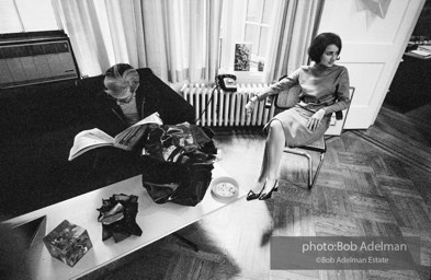 Andy Warhol and Kay Bearman. Andy Warhol reads the small ads in the Village Voice. Leo Castelli Gallery. New York City, 1965.