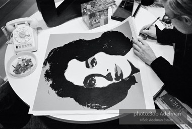 Andy Warhol signs his Liz Taylor prints at the Leo Castelli Gallery. New York City, 1965. Andy Warhol signs his Liz Taylor prints at the Leo Castelli Gallery. New York City, 1965.