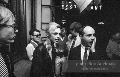 Andy Warhol and  entourage late at night outside a NYC night club, 1865