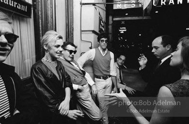 Andy Warhol and  entourage late at night outside a NYC night club, 1865