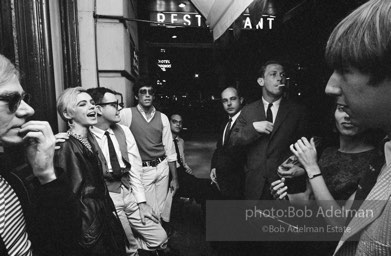 Andy Warhol and  entourage late at night outside a NYC night club, 1865