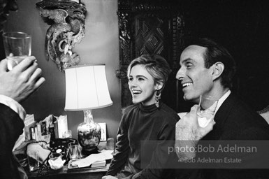Edie Sedgwick and Fred Eberstadt sit on an antique bed at a society party. New York City, 1965.