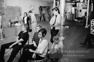 Watching a screeing of a film at the Factory, 1965.