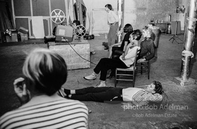 Watching a screeing of a film at the Factory, 1965.