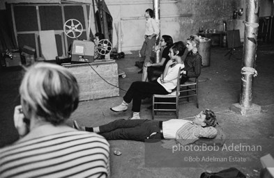 Watching a screeing of a film at the Factory, 1965.
