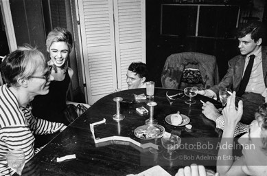 Andy Warhol and Edie Sedgwick with unidentified guests at an east-side dinner party. New York City, 1965.