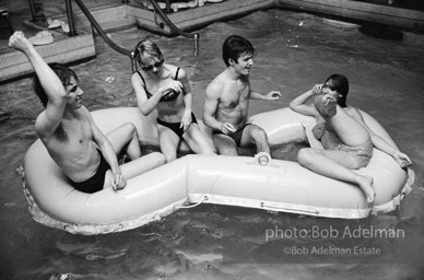 left to right: Chuck Wein, Edie Sedgwick, Gerard Melanga, unidentified. Pool party at Al Roon's gym. New York City, 1965.