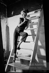 Edie Sedgwick on the steps leading
to Billy Name’s sleeping quarters
at the Factory. 1965.