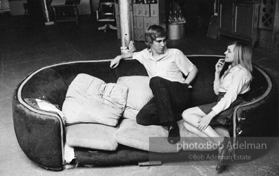 Bibbe Hanson and Chuck Wein on the infamous red couch at Warhol's Factory. New York City, 1965.