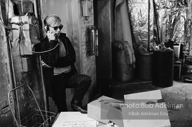 Andy Warhol at the payphone at the Factory. 1965.