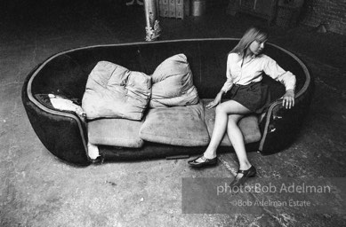 Bibbe Hanson on the red couch at Andy Warhol's Silver Factory, New York City, 1965.