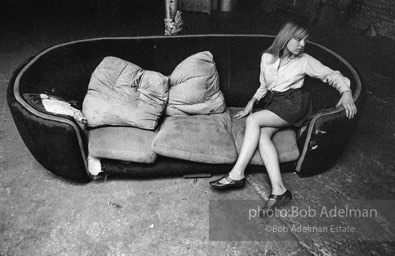 Bibbe Hanson on the red couch at Andy Warhol's Silver Factory, New York City, 1965.