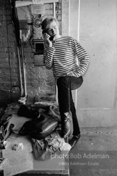 Andy Warhol at the payphone at the Factory. 1965.