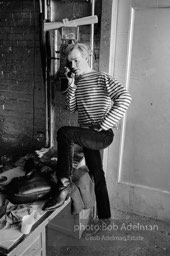 Andy Warhol at the payphone at the Factory. 1965.