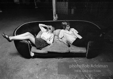 Bibbe Hanson and Chuck Wein on the infamous red couch at Warhol's Factory. New York City, 1965.