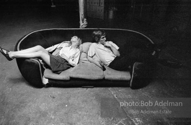 Bibbe Hanson and Chuck Wein on the infamous red couch at Warhol's Factory. New York City, 1965.