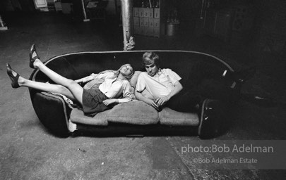 Bibbe Hanson and Chuck Wein on the infamous red couch at Warhol's Factory. New York City, 1965.