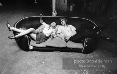 Bibbe Hanson and Chuck Wein on the infamous red couch at Warhol's Factory. New York City, 1965.